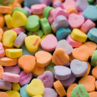 A close-up of lots of multi-coloured love heart sweets