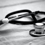 A close up of a stethoscope on top of some white material
