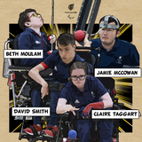 A photo showing a woman in a wheelchair in an outside setting throwing a red Boccia ball. Two men are either side of the woman