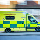 an ambulance going at full speed down a road