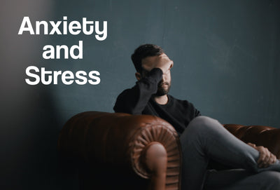 A man sitting on a sofa; his hand is raised to his head, although stressed. The words – Anxiety and Stress – can be seen