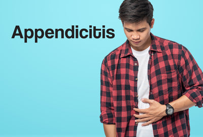 A man in a white t-shirt and a black and red lumber jack shirt has his left hand against his stomach - he looks in pain. The word – Appendicitis – can be seen
