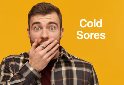A man covering his mouth with his hand looking shocked. The words – Cold Sores – can be seen