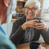 The image shows two people enjoying meeting up for a coffee