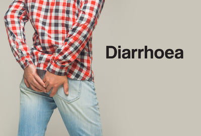 The back view of a clothed man. He has both of his hands against his bottom. The word – Diaarhoea – can be seen