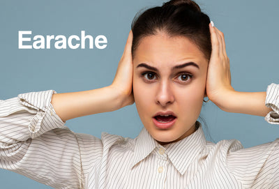 A woman with both of her ears over her ears. The word – earache – can be seen