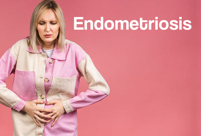 A middle aged woman in a checked (pink and white) shirt, is clutching her stomach, as though in pain. The word – Endometriosis – can be seen