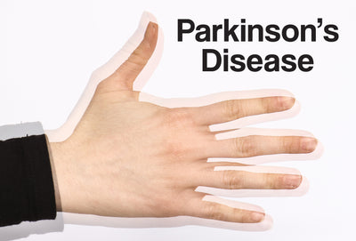 A close up of a person's hand – it is shaking, as it would with a hand tremor. The words – Parkinson's disease – can be seen