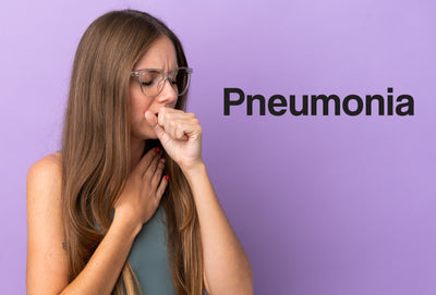 A young woman has an arm against her chest and a hand against her mouth, although she's coughing and is in pain. The word – Pneumonia – can be seen