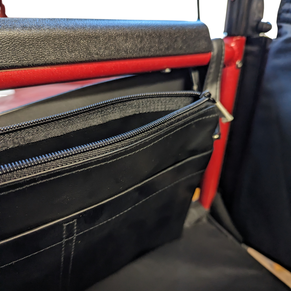 Simplantex Side Pouch attached to side of wheelchair, main pouch unzipped