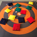 The image shows 12 bean bags on a target mat on the floor