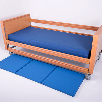 The Bed Fall Safety Mat, next to a bed.