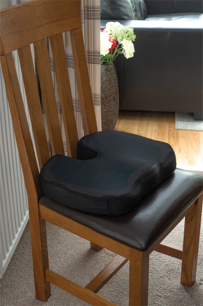 Deluxe Pressure Relief Coccyx Cushion with Gel being used on a living room chair