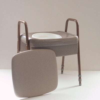 the image shows the ashby height adjustable commode with the seat cover placed to one side