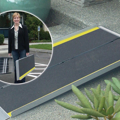 the image shows a woman carrying the advantage suitcase ramp, in two sections, each with a handle