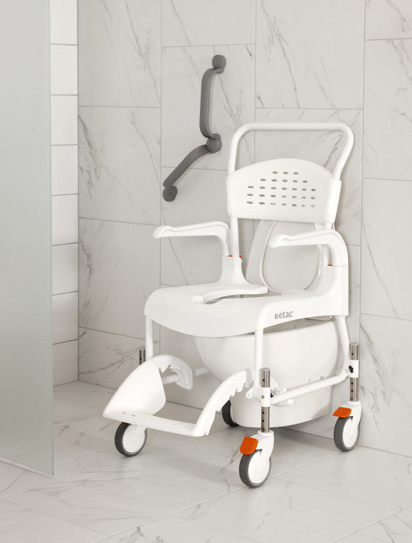 The image shows an Etac Clean Shower Commode Chair placed over a wall mounted toilet