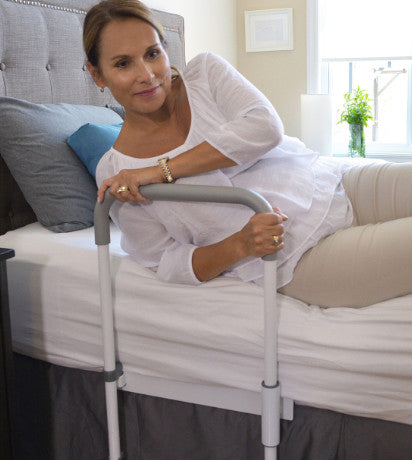 shows a woman using the smart-rail bed rail