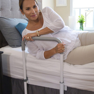 shows a woman using the smart-rail bed rail