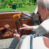 the image shows a man using a classic canes folding derby cane to help him to safely get of a car.