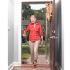 shows a woman moving through a front-door with a step, using the Flip-A-Grip Support Handle