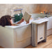 Woman in bath with the Molly Bather Belt Bath Lift next to the tub