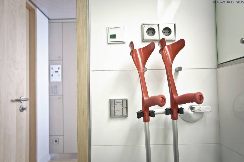 the image shows the mobeli dual cane holder secured to a wall holding two crutches