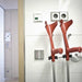 the image shows the mobeli dual cane holder secured to a wall holding two crutches