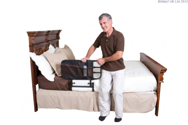 Picture of EZ Adjustable Bed Rail with Pouch from Stander on a bed with a man using it to get up