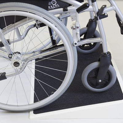 the image shows a wheelchair using a fibreglass threshold ramp