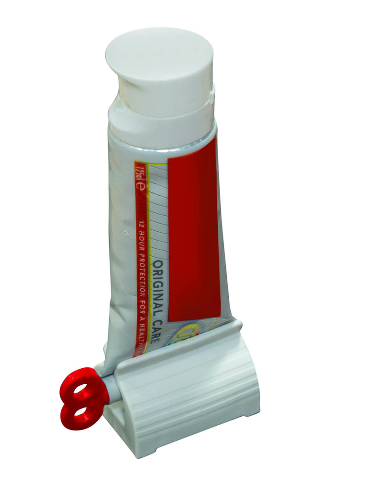 shows the tube squeezer with red key being used to squeeze toothpaste
