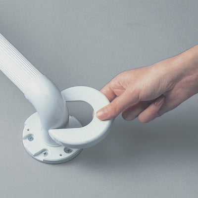 shows a person's hand fixing a spare covering disc onto a grab rail