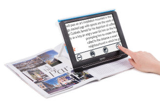 shows someone using the compact 10 hd magnifier to read a magazine