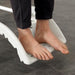 The image shows the unique foot support on the Etac Clean Shower Commode Chair