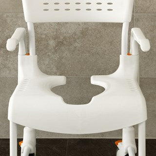 The image shows a close up photo of the seat on an Etac Clean Shower Commode Chair