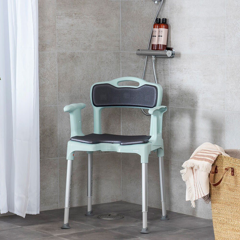 the image shows a green etax swift in a shower with the back support pad on it