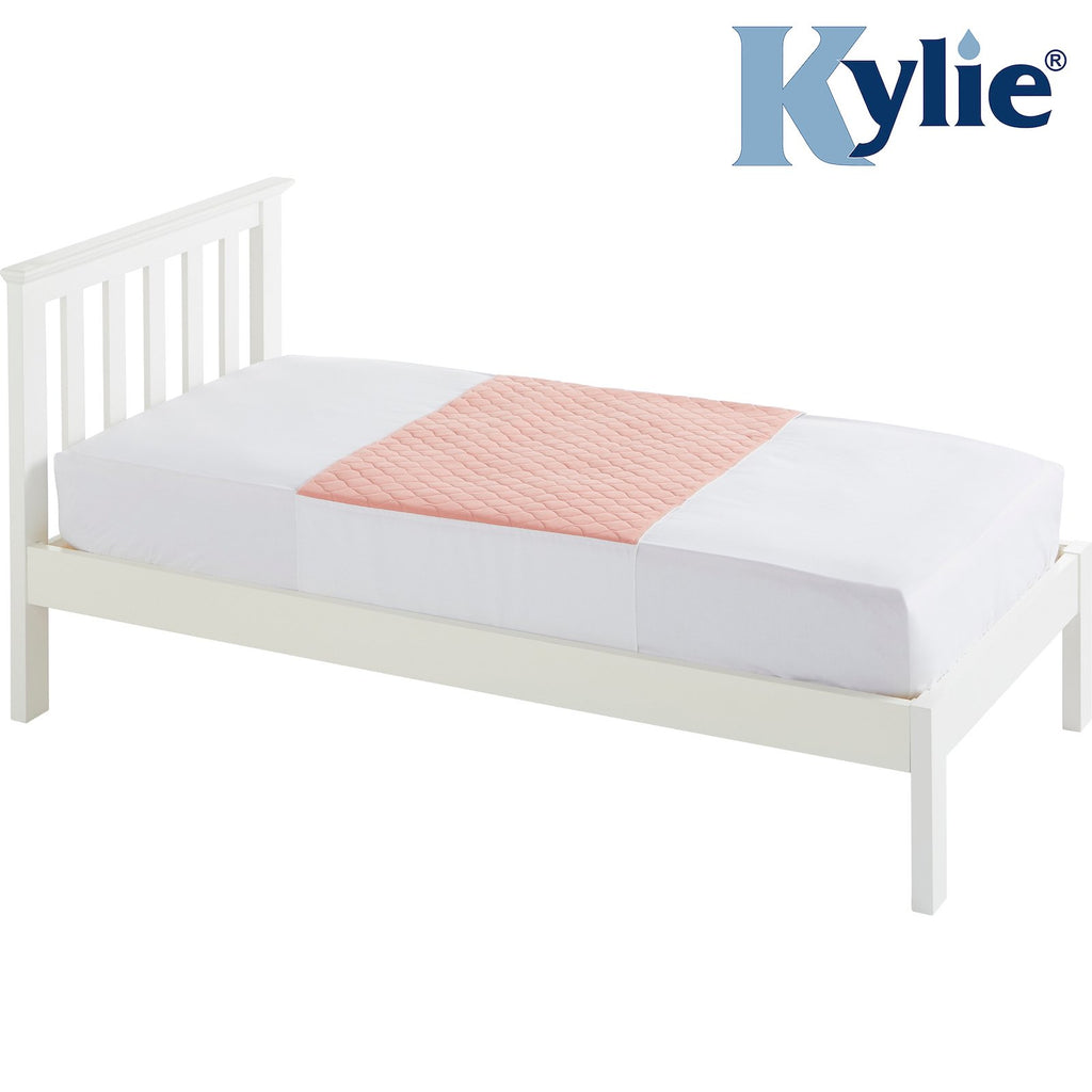 the image shows the pink kylie bed pad on a single bed