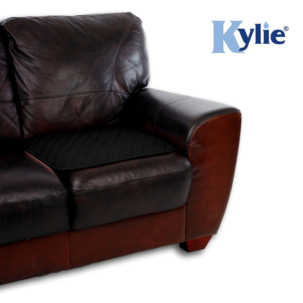 A Black Kylie Chair Pad on a leather sofa