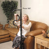 shows a woman with blonde hair sitting on a leather couch and holding on to the black version of the security pole