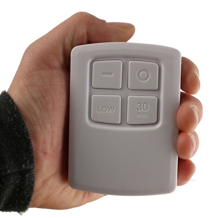 the image shows a hand holding the lifemax remote control for the wireless LED lights
