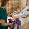 shows a nurse putting an ehob waffle heel elevator on a patient