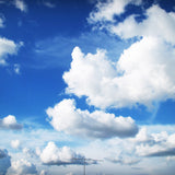 A beautiful rich blue sky with some fluffy clouds