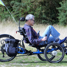 A picture of a man riding a recumbent trike