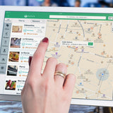 A close-up of two hands holding a tablet that has Google Maps on it