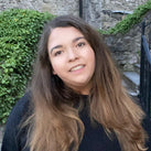 Haley Neville standing in front of a stone wall