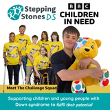 A close-up of Lloyd-Martin holding a Pudsey Bear. The other children taking part in the BBC's Children in Need, Challenge Squad, can also be seen along with the Children in Need logo