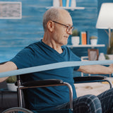 An image of a man in a wheelchair using a stretch band to exercise with
