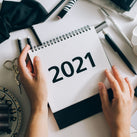 the image shows someone holding a 2021 calendar