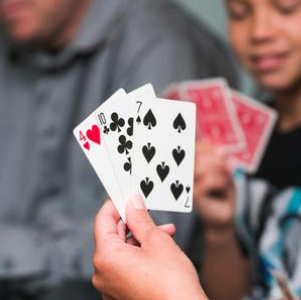 the image shows someone playing cards