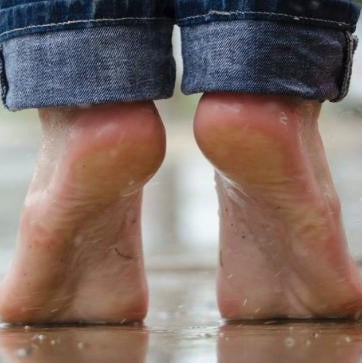 the image shows someone standing on the tips of their toes
