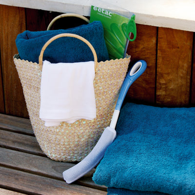 Wash basket filled with towels and long handled washers